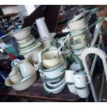 A LARGE COLLECTION OF VINTAGE CREAM AND GREEN ENAMEL KITCHENALIA