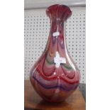 A MEDINA STYLE VASE IN RED with swirl decoration, 33cm high