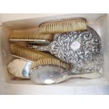 FIVE-PIECE SILVER BACKED DRESSING TABLE SET, a further silver-backed hand mirror with embossed