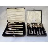 A SET OF CASED SILVER TEA SPOONS, also with silver and mother of pearl knives in a fitted