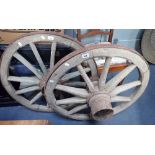 TWO 19TH CENTURY ELM CART WHEELS, with wooden spokes and hubs and metal surrounds, each 83cm dia. (