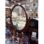 A VICTORIAN MAHOGANY DRESSING TABLE MIRROR with lift up flap and oval plate, 57cm wide