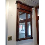 A EARLY 19TH CENTURY MAHOGANY FRAMED PIER GLASS with spiral turnings and broad cornice, 68cm x