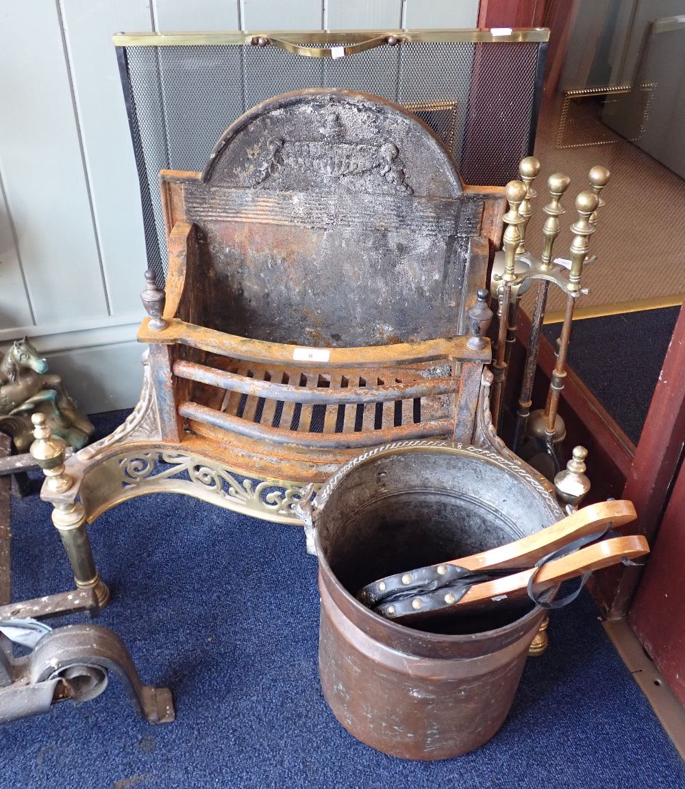 AN ADAM STYLE CAST IRON AND BRASS FIRE GRATE, 57cm high x 63cm wide (overall) with brass fire