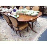 A REGENCY STYLE MAHOGANY D END DINING TABLE with two extra leaves, the ends on gun barrel and urn