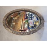 A SILVER FRAMED DRESSING TABLE MIRROR, the border embossed with birds and scrolls, 24cm x 16.5cm