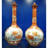 A PAIR OF JAPANESE BOTTLE VASES with lids, 32cm high (one cracked)