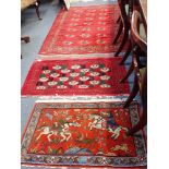 A PERSIAN RUG WORKED WITH A HUNTING SCENE, 60cm x 100cm, a tekke Bokhara style rug with red ground