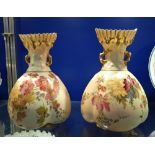 A PAIR OF ROYAL WORCESTER BLUSH IVORY VASES decorated with flowers, 21.5cm high