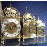 THREE 'LANTERN' CLOCKS of graduated sizes, 28cm, 25cm and 17cm high