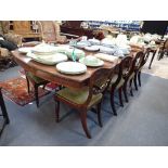 A GEORGE III STYLE MAHOGANY DINING TABLE with two extra leaves on downswept legs, 112cm wide x 255cm