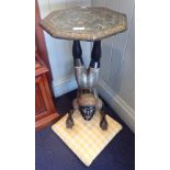 A 'BLACKAMOOR' FIGURE OF A BOY DOING A HANDSTAND, with an octagonal carved top on an upholstered