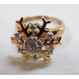 A DIAMOND SPINNING SNOWFLAKE RING, on a gold shank stamped '375', ring size O