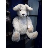 A VINTAGE OFF WHITE TEDDY BEAR, with jointed limbs, 68cm high