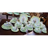 SHELLEY; AN EXTENSIVE 1920S TEA SET with flowers within a yellow and green border