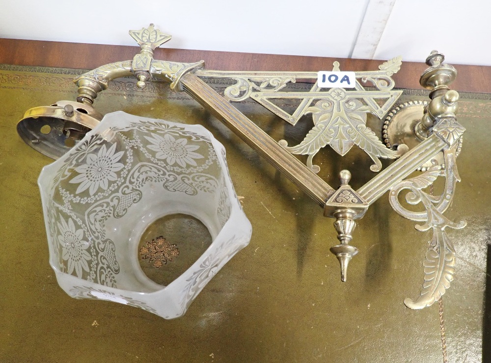 A VICTORIAN AESTHETIC STYLE BRASS GAS BRACKET, with an original frosted shade (converted to