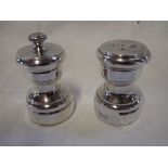 CARTIER: A PAIR OF STERLING SILVER SALT AND PEPPER SHAKERS, 6.5cm high (2)