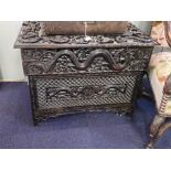 A CHINESE CARVED HARDWOOD FOLDING DESK with openwork and relief carved panels with serpents, dragons