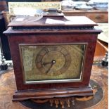 A 1930S MANTEL CLOCK in a bird's eye walnut case, by Finnigans (moulding missing)