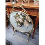 A VICTORIAN CIRCULAR BRASS FRAMED MIRRORED FIRE SCREEN painted with a bird and Briar Roses on