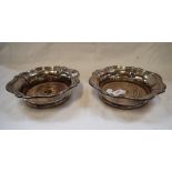 A PAIR OF SILVER PLATED WINE COASTERS, of lobed form