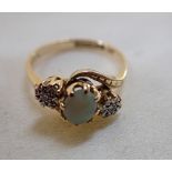 AN OPAL AND DIAMOND RING, on an 18ct yellow gold shank, ring size M