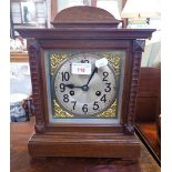 AN EDWARDIAN OAK CASED MANTEL CLOCK