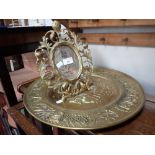 A CAST IRON AND GILT PAINTED FLORENTINE STYLE MIRROR and an embossed brass plaque
