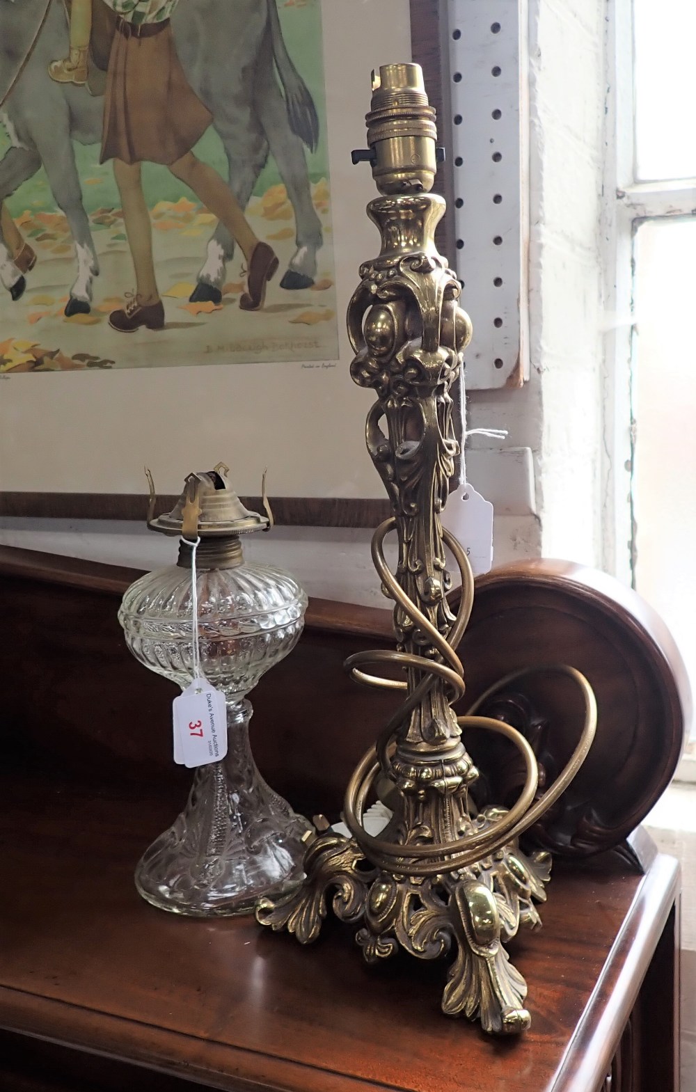 A ROCOCO BRASS TABLE LAMP and a pressed glass oil lamp