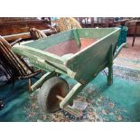 A LARGE 19TH CENTURY WOODEN WHEELBARROW (with later front wheel) 151cm long (overall)