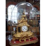 A 19TH CENTURY FRENCH GILT SPELTER MANTEL CLOCK, decorated with a young woman under a (damaged) glas