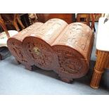 A INDONESIAN CARVED CAMPHER WOOD CHEST OF TRIPLE BARREL FORM, 102cms wide