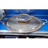 A SILVER PLATED METAL TWIN HANDLED OVAL TRAY, 76CM WIDE; AND A SILVER PLATED METAL WAITER