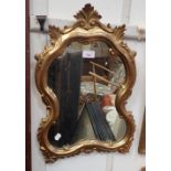 A ROCOCO STYLE GILT FRAMED MIRROR 37cms wide