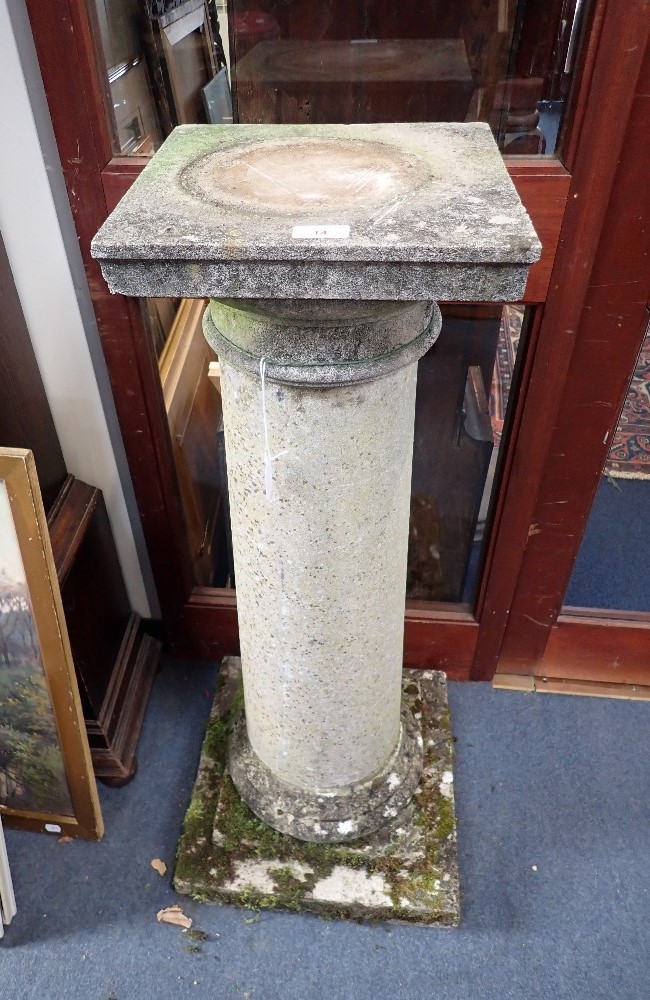 A PAIR OF WEATHERED RECONSTITUTED STONE COLUMNS with square bases and capitals, 97cm high