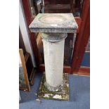 A PAIR OF WEATHERED RECONSTITUTED STONE COLUMNS with square bases and capitals, 97cm high