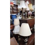 A BRASS CORINTHIAN COLUMN TABLE LAMP, a Benares brass lamp and others similar