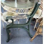 A PAIR OF GREEN PAINTED CAST BENCH ENDS of scrolling form