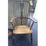 A STAINED HARDWOOD WINDSOR STYLE ELBOW CHAIR, the spindle back with pierced splat and arched toprail