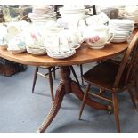 A REGENCY STYLE MAHOGANY D END DINING TABLE with two extra leaves, the ends on gun barrel and urn tu