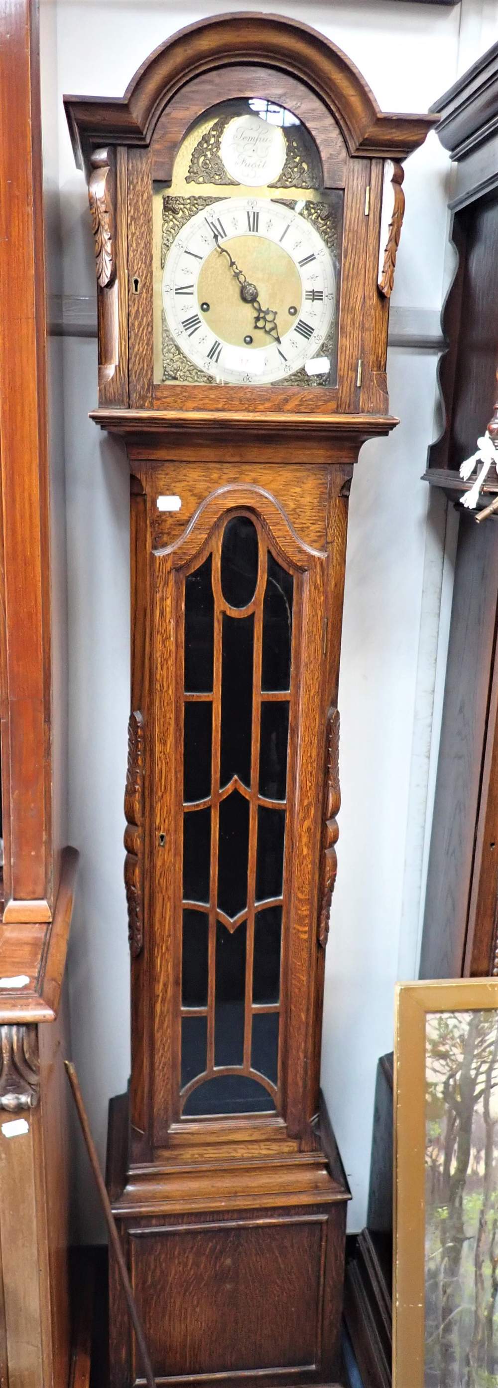 A 1920S OAK CASED GRANDMOTHER CLOCK with three train movement and brass and silvered dial, 168cm hig