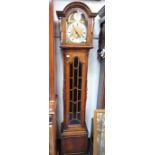 A 1920S OAK CASED GRANDMOTHER CLOCK with three train movement and brass and silvered dial, 168cm hig