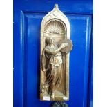 A CAST BRASS PLAQUE OF A WOMAN PLAYING A TAMBOURINE in relief, 54cm high