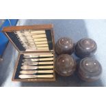 FOUR LIGNUM VITAE BOWLING WOODS and a boxed set of fish knives and forks