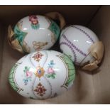 THREE RUSSIAN PORCELAIN EASTER EGGS decorated with enamel and gilt