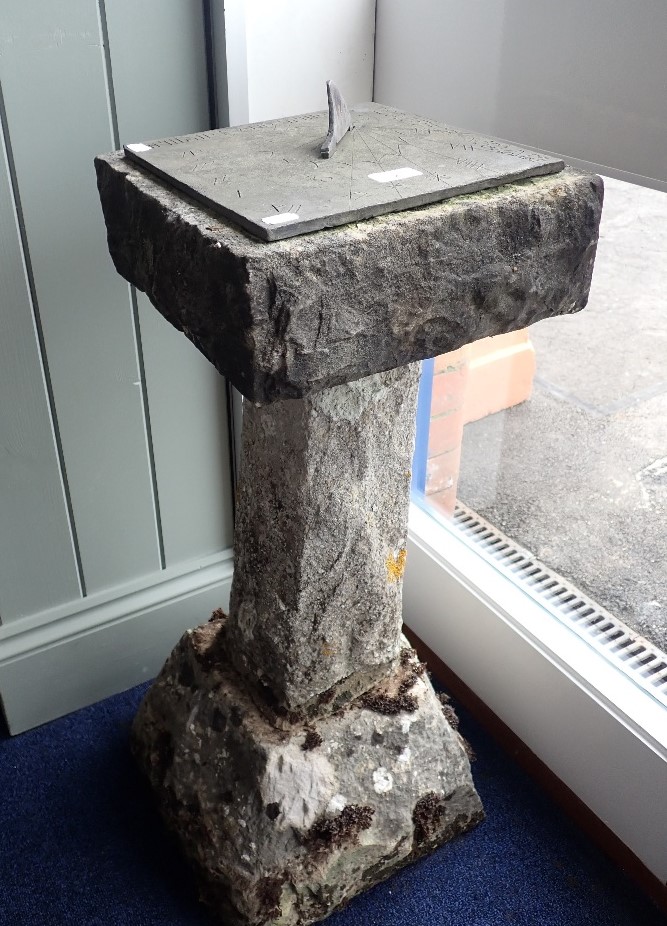 A SUN DIAL ON A RUSTICATED STONE BASE, 79cm high 'Time and Tide wait for no Man'