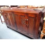 AN OAK SIDEBOARD WITH CARVED DECORATION, the interior fitted with drawers, 144cm wide
