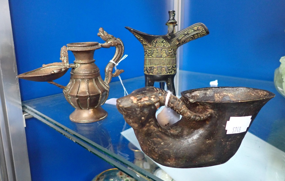 AN ORIENTAL PATINATED BRONZE VESSEL with an animal head and four character mark below and two simila