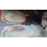 A CHINESE STYLE CIRCULAR WOOL RUG, 135cm diameter; AND AN OVAL EXAMPLE, similar, 155cm long