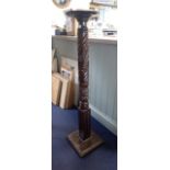 A VICTORIAN CARVED AND STAINED MAHOGANY TORCHERE STAND, late 19th century, with circular top and squ